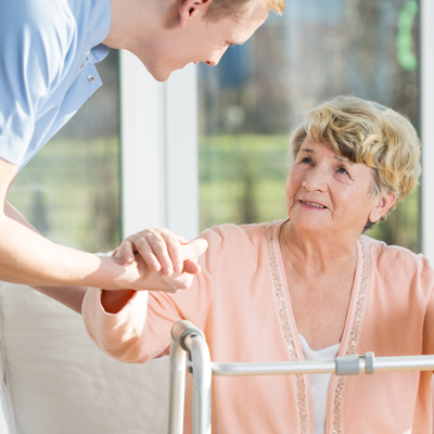 senior woman being helped up by healthcare worker