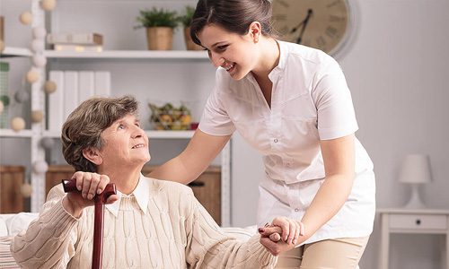 senior woman being helped by a healthcare worker