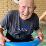 senior man smiling in pool