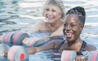 Senior woman and friend doing water aerobics