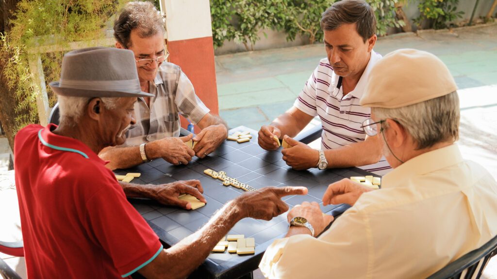 Active Retirement Happy Old Friends Playing Domino Game