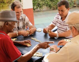 Active Retirement Happy Old Friends Playing Domino Game
