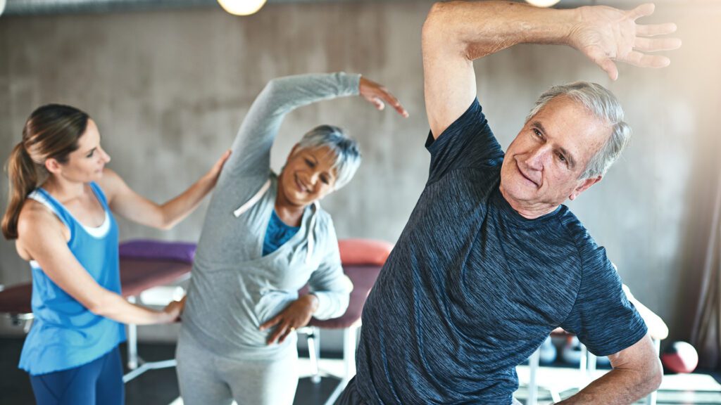 seniors stretching with instructor