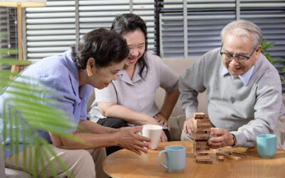 older adults playing jenga at home, one of the best sit down games for senior citizens