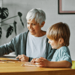 active older adult playing scrabble with young child