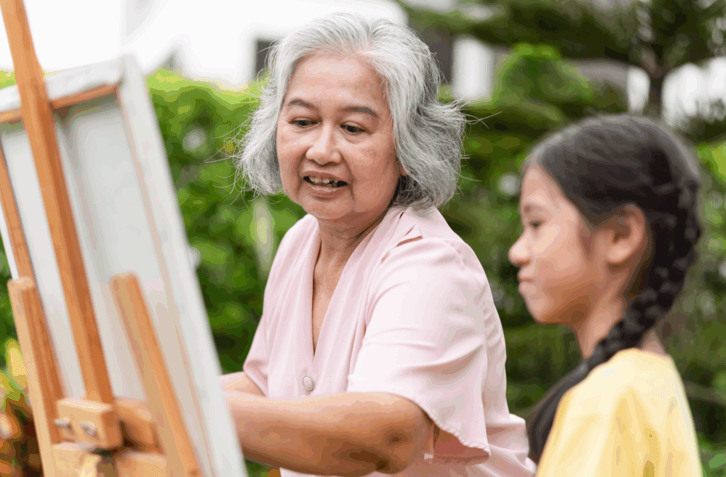 intergen-painting older adult painting with young student