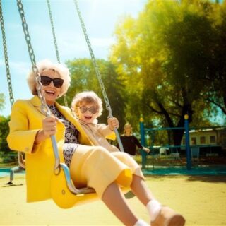 grandma and son swinging outside at a park in arizona winter weather