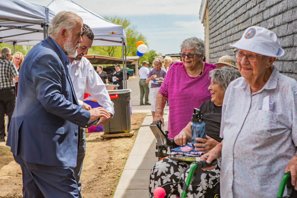 Glencroft resident greeting guest at Bezos Academy ribbon cutting