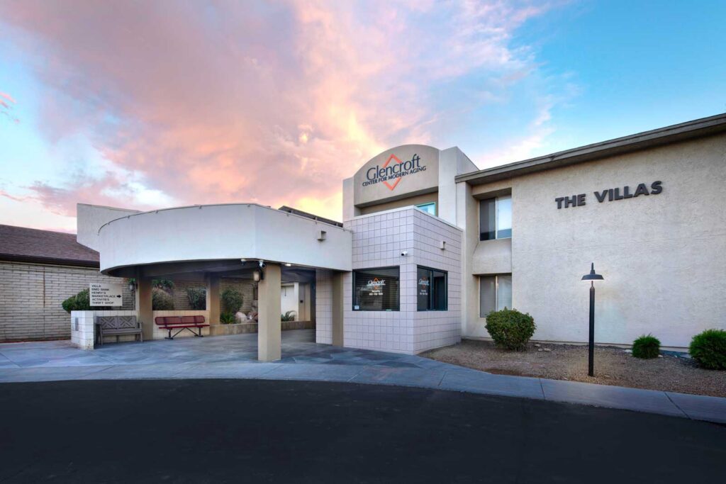 Exterior entrance of Glencroft Villas senior living community in Glendale, Arizona at sunset