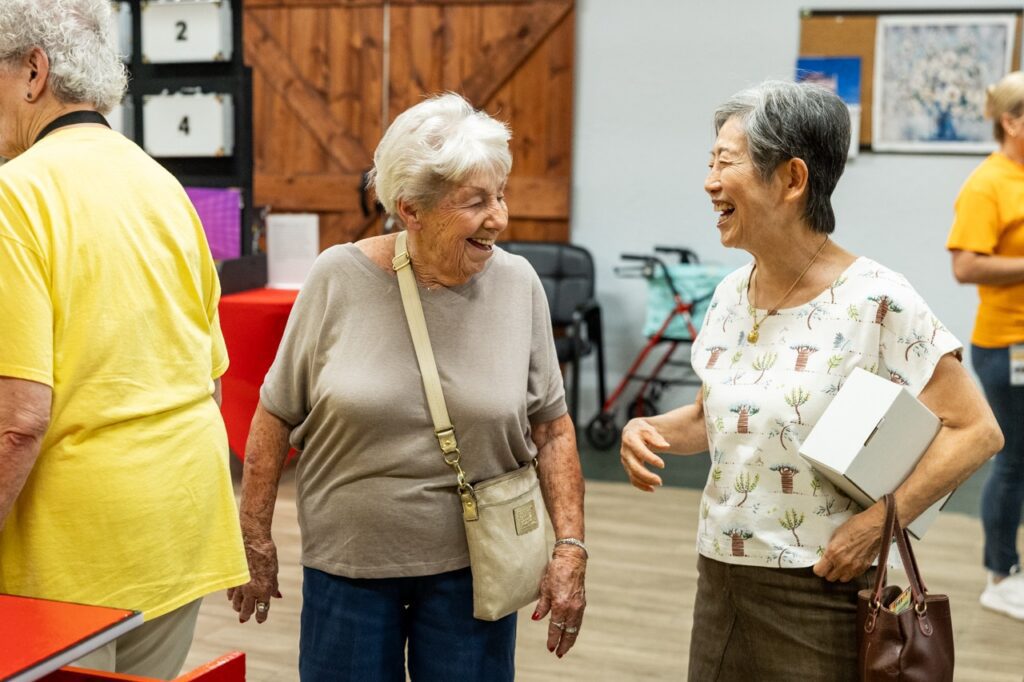 Two women laughing together at Glencroft Game Show Week