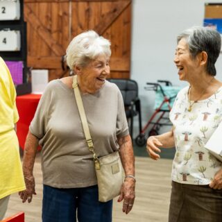 Two women laughing together at Glencroft Game Show Week